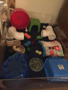 an assortment of items sitting on top of a blue tray in a living room next to a wall