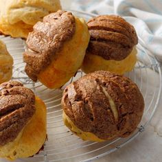 several pastries sitting on a wire rack