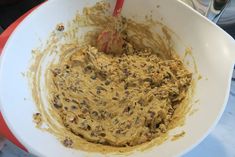 a mixing bowl filled with batter and chocolate chips on top of a marble countertop