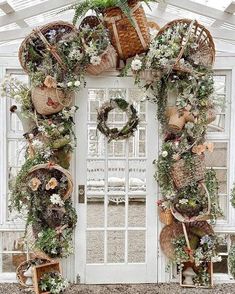 a white door decorated with plants and baskets