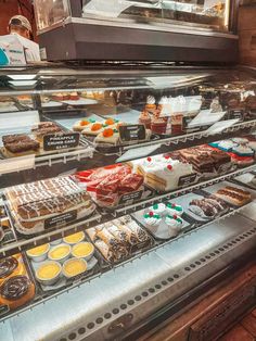 a display case filled with lots of cakes and desserts