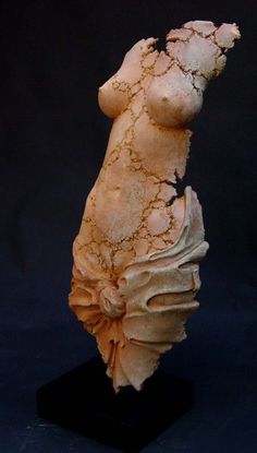 a sculpture of a woman's torso on a black base