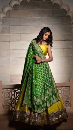 a woman in a green and yellow lehenga