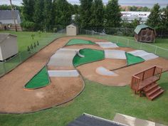 a skateboard park with ramps and green grass