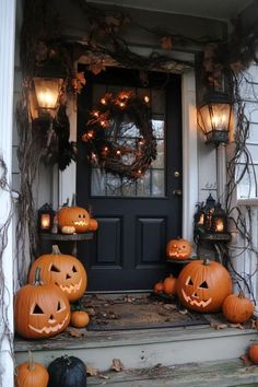 pumpkins are sitting on the front steps of a house with lanterns and wreaths