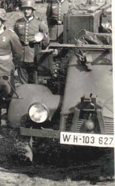 an old black and white photo of men in uniform standing next to a fire truck