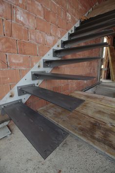 the stairs are made of steel and have been placed on top of wooden planks