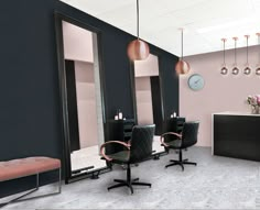 the salon is decorated in black and pink tones, with modern lighting fixtures hanging from the ceiling