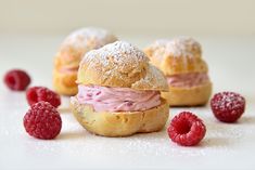 raspberry pastries with powdered sugar on them and fresh raspberries