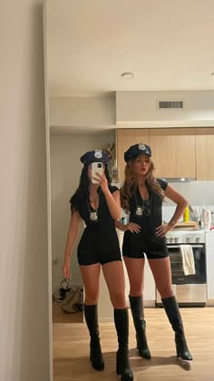 two women dressed in police uniforms taking a selfie