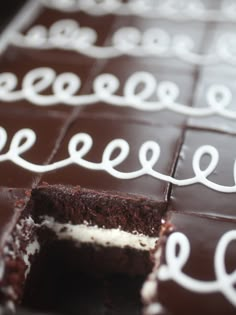 a chocolate cake with white icing is cut in half