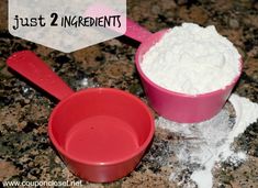 two red bowls with white powder in them on a granite counter top next to a pink measuring spoon