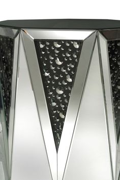 a glass vase with silver and black designs on it