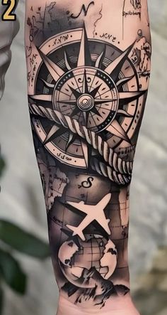 a man's arm with a compass tattoo on it