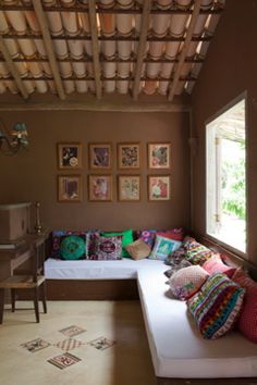 a living room filled with lots of colorful pillows