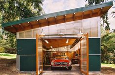 a car is parked in front of a garage with an awning on the roof