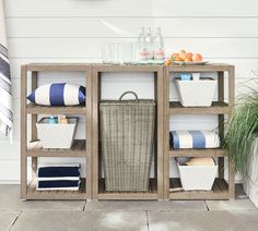 a shelf with baskets and towels on it