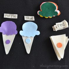 three ice cream cones with words on them and one has an orange, purple, and blue cone