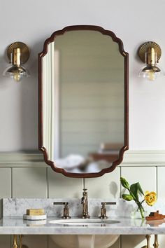 a bathroom with two sinks and a large mirror on the wall above it's counter