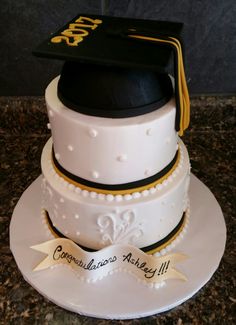 a graduation cake with a hat on top