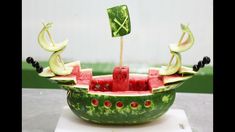 a boat made out of watermelon and other fruits