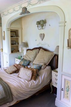 a bed sitting in a bedroom next to a doorway