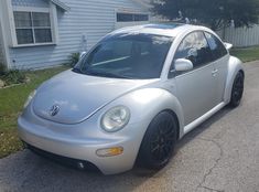 a silver car parked in front of a house