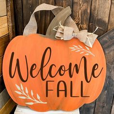 a wooden sign that says welcome fall on top of a white box with a bow