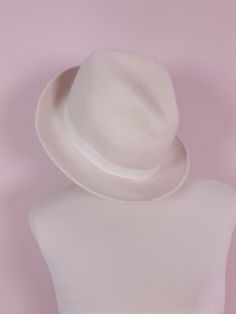 "Experience timeless style with our vintage fedora hat. This 1970s Italian-made fedora is crafted from high-quality cream wool. Finished with a cream ribbed ribbon. Era - 1970s Fabric - Wool Inner rim 8\" length x 6\" width Outer hat - 12\" length x 10.5\" width Label size 85 Great condition" Vintage White Fedora With Short Brim, Fitted Cream Vintage Fedora, Vintage White Fedora Hat, Vintage White Brimmed Hat, 1970s Fabric, Wool Fedora Hat, Fabric Wool, Wool Fedora, Prairie Dress