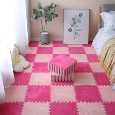 a pink and white checkered floor in a bedroom with a plant on the corner