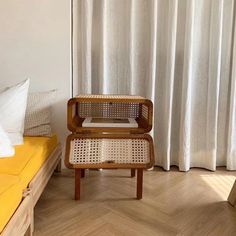 a small wooden chair sitting on top of a hard wood floor next to a bed