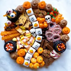 a platter filled with halloween treats and candies