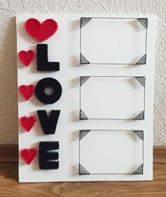 the word love spelled out with felt hearts on a white card board that says i love you