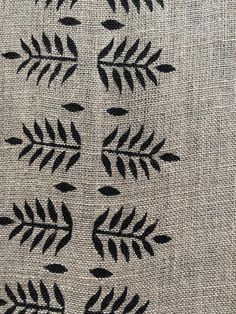 an embroidered cloth with black leaves on it