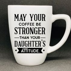 a white coffee mug that says may your coffee be stronger than your daughter's attitude