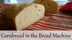 a loaf of bread sitting on top of a striped table cloth with the words cornbread in the bread machine