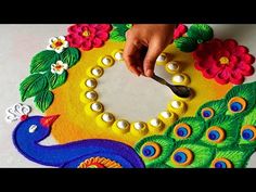 someone is making a peacock decoration with beads and pearls on the table next to it