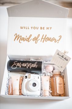 an open box containing personal care items and a card that says, will you be my maid of honor?