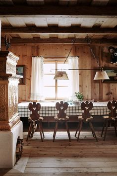 a dining room with wooden walls and chairs