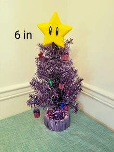 a purple christmas tree with a yellow star on top