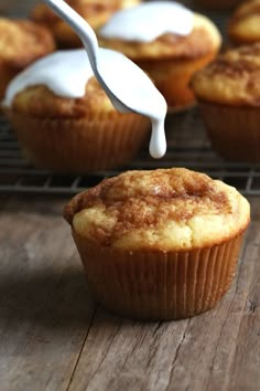 a muffin being drizzled with white icing