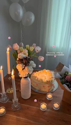 a table topped with a cake surrounded by candles