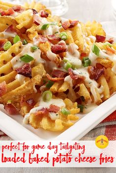 a white plate topped with cheesy french fries covered in bacon and ranch dressing