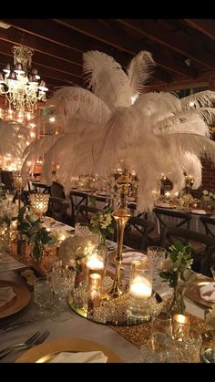 a table is set with candles and centerpieces for an elegant dinnereon party