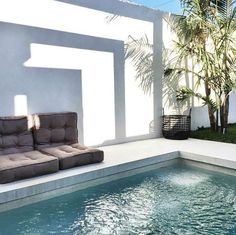 a couch sitting next to a swimming pool