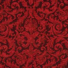 a red and black background with an intricate design on it's surface, in the middle