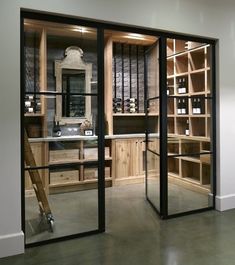 the inside of a wine cellar with glass doors