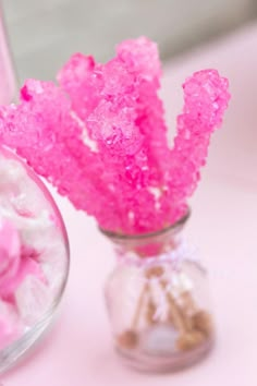 there are pink candy in the glass vase