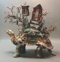 a turtle with two lamps on top of it's head and trees growing out of its back