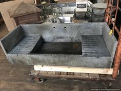 an industrial sink is being worked on in a shop with other tools and materials around it